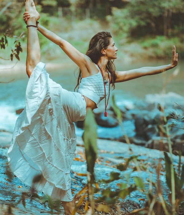 Woman in a calm, flowing yoga pose, suggesting flexibility and balance.